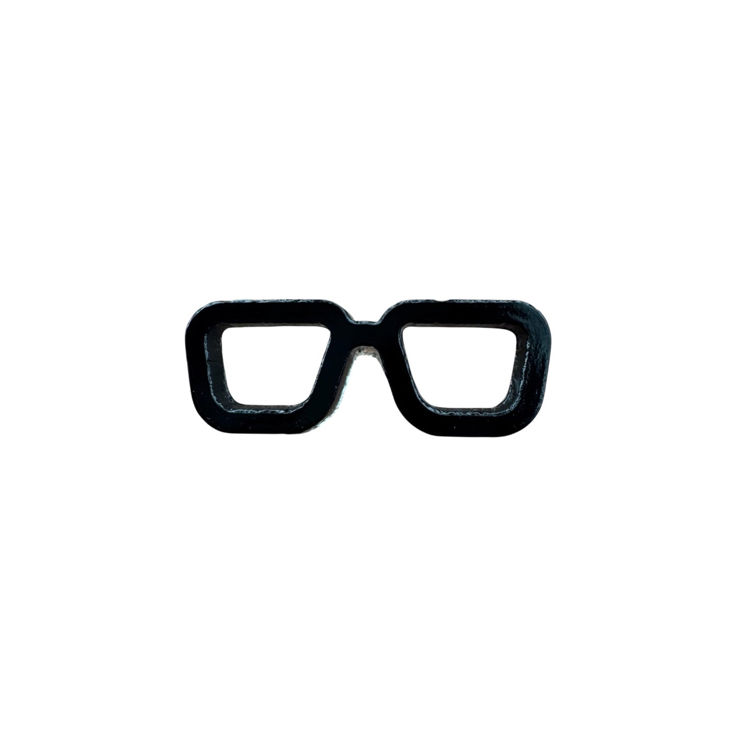 Black eyeglass frames pin on a white background