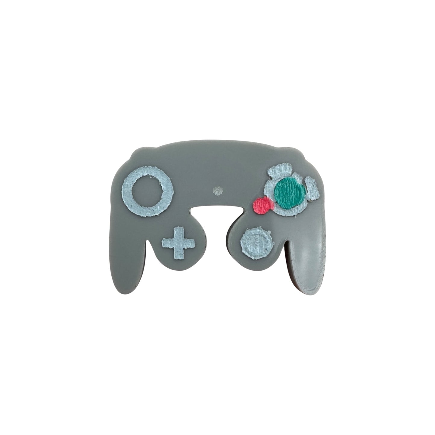 Gray gaming controller-shaped pin on a white background