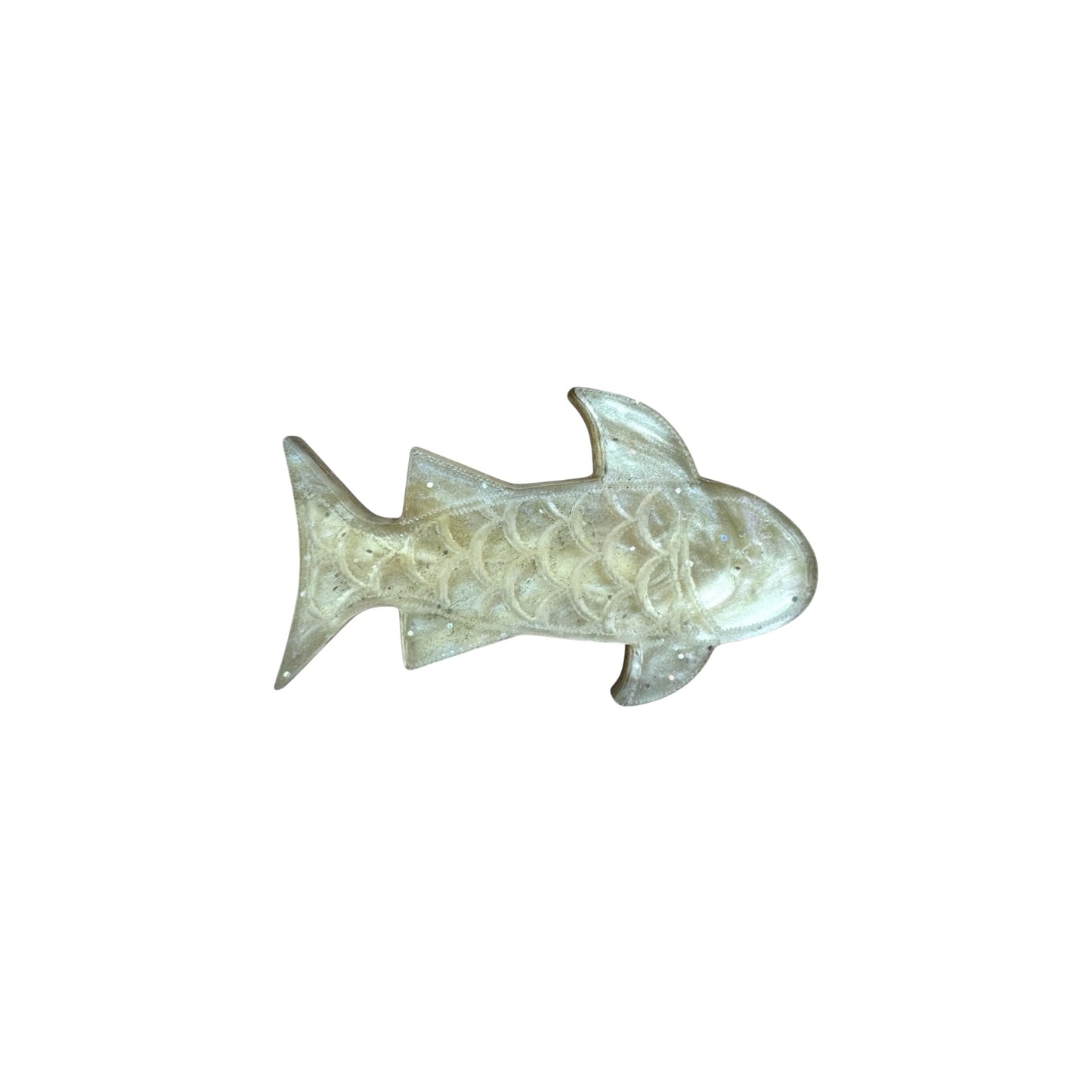 Gold colored fish pin on a white background