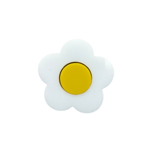 White daisy-shaped pin with a yellow center on a white background

