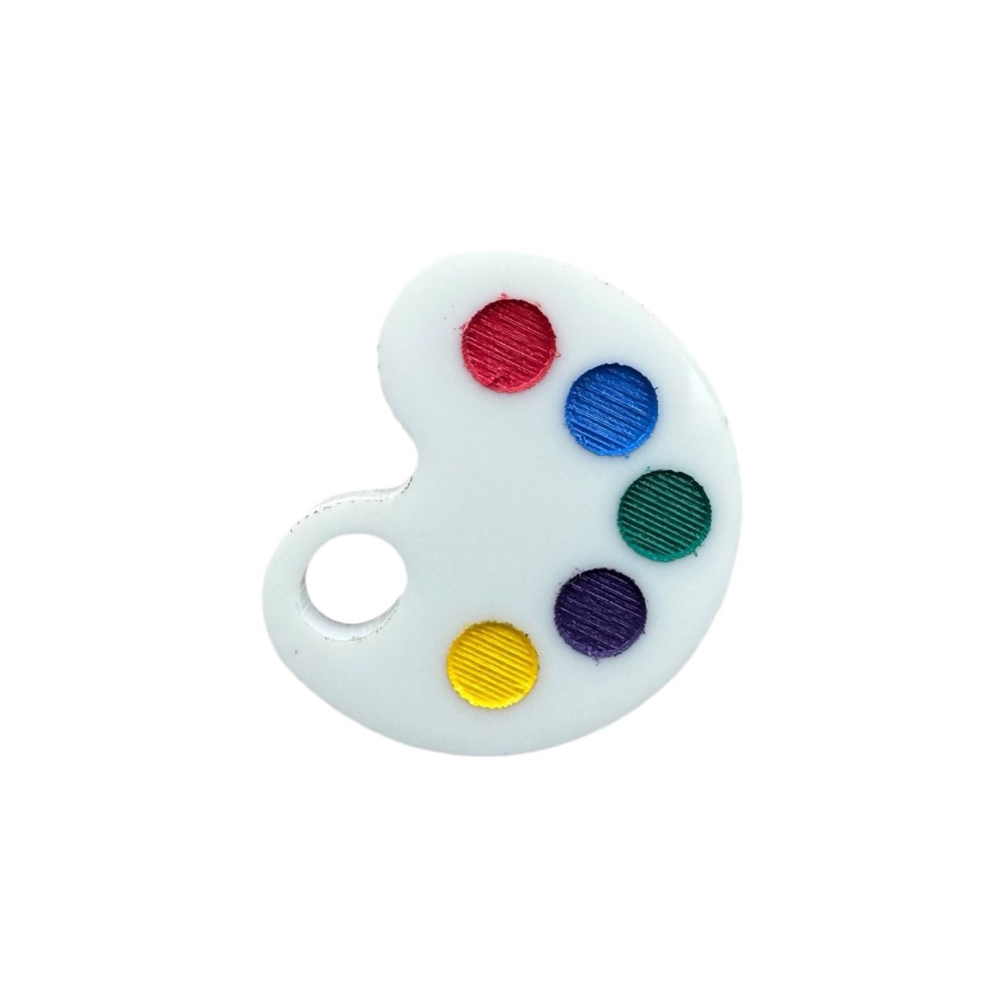 Small round painter's palette with red, blue, green, purple, and yellow colors on a white background