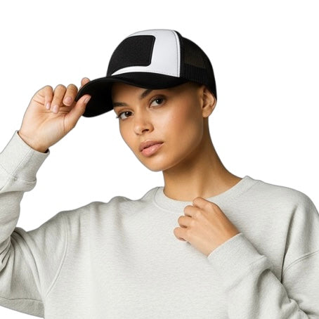 Person wearing a black and white cap and gray sweatshirt on a white background