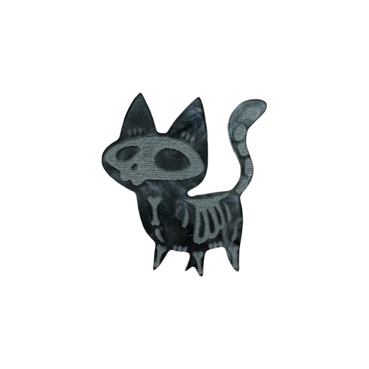 Black and grey skeleton cat designed pin on a white background

