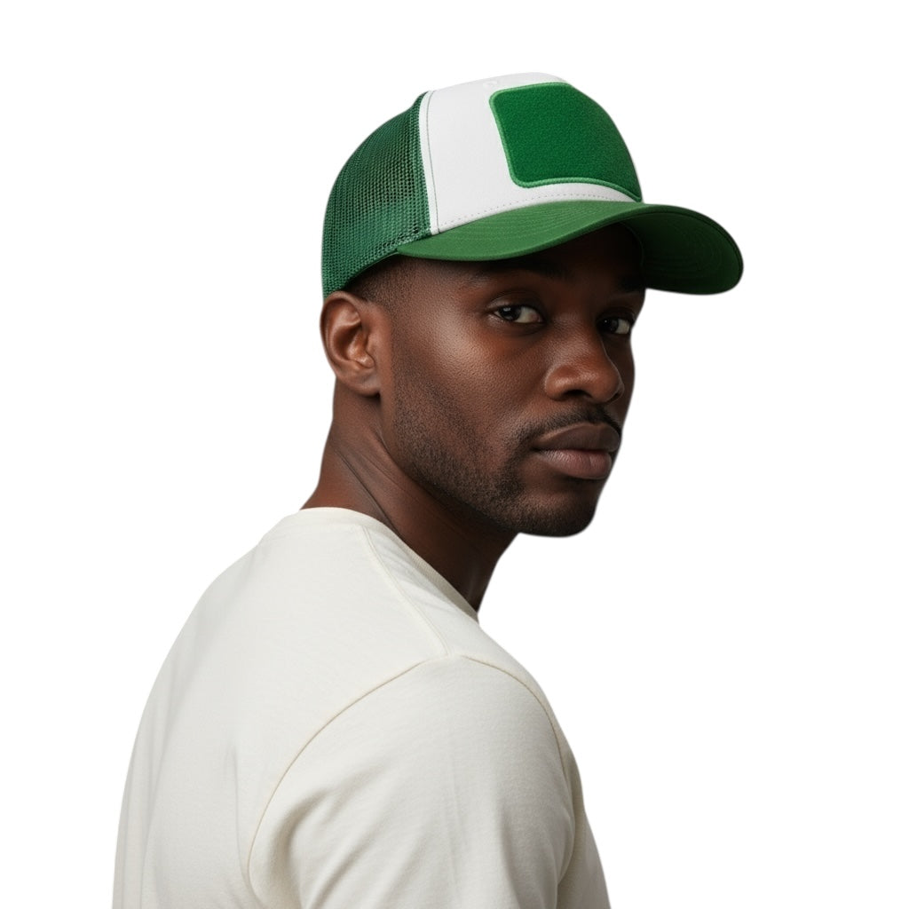 Man wearing a green and white trucker hat on a white background