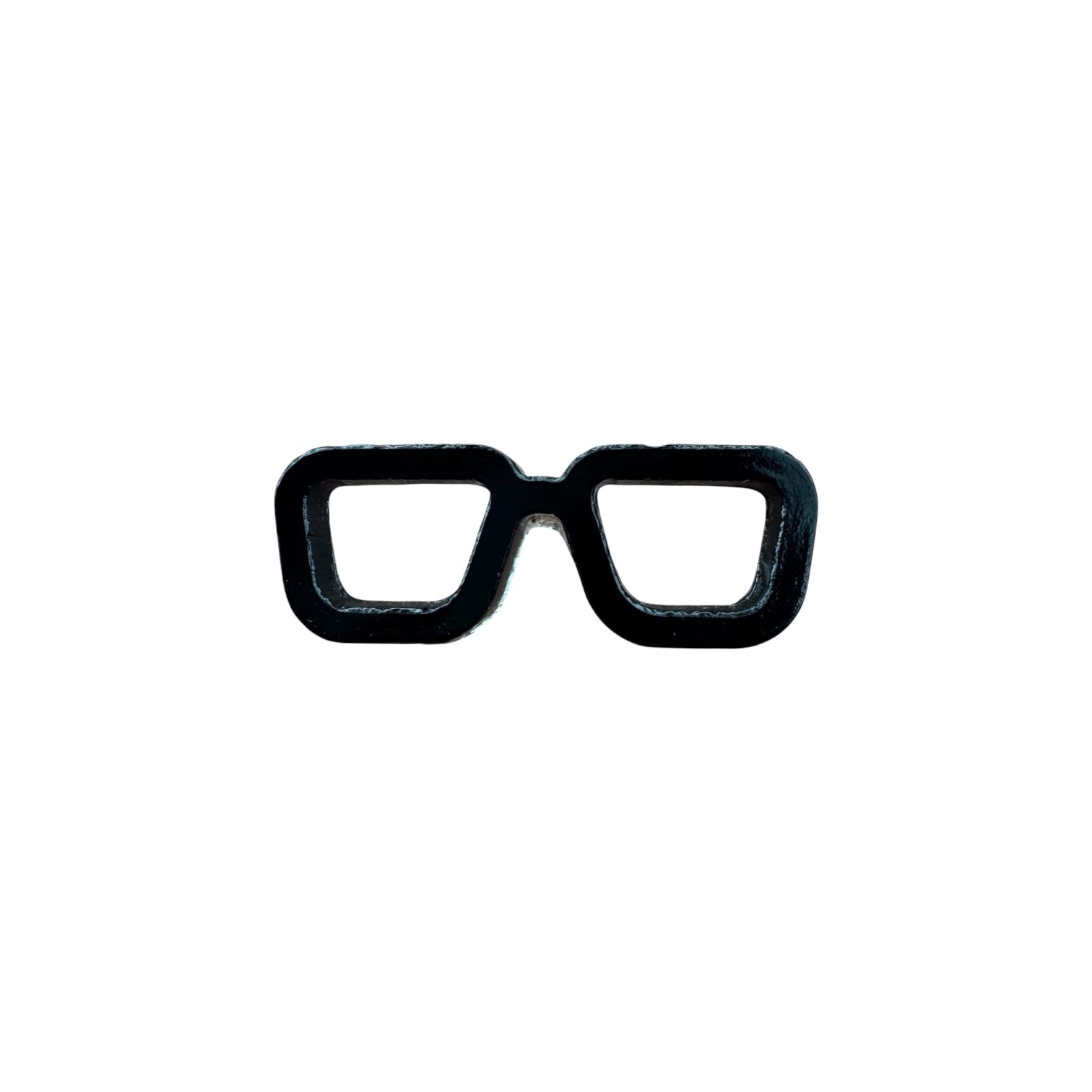 Black eyeglass frames pin on a white background