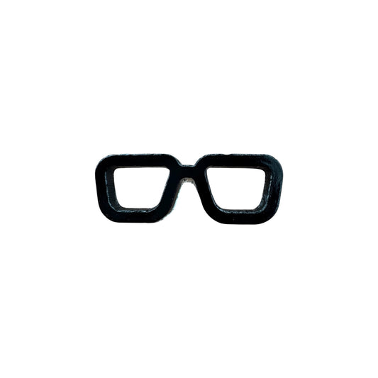Black eyeglass frames pin on a white background