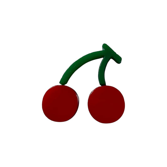 Cherry-shaped pin with red berries and green stems on a white background

