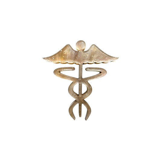 Gold caduceus-shaped pin on a white background

