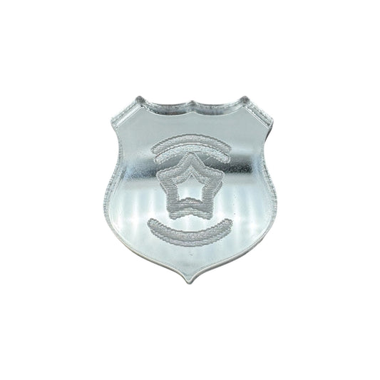 Pin of a metallic police badge with star emblem on a white background
